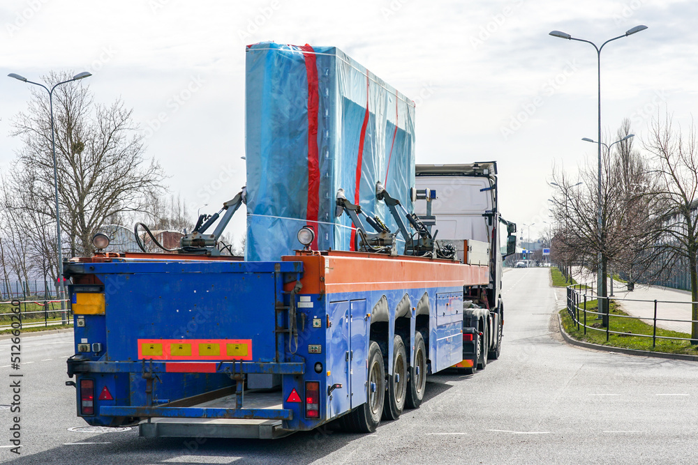 Naklejka premium Transportation of reinforced concrete prefabricated wall panels for house construction by truck
