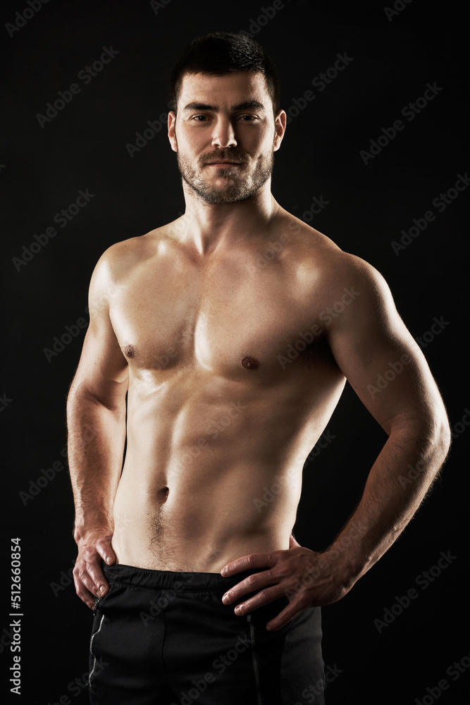 Looking this good takes hard work. Studio portrait of a sporty young man isolated on black.