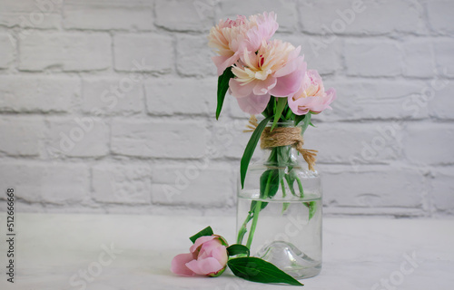 Fototapeta Naklejka Na Ścianę i Meble -  Beautiful peony flower in a vase on an old background