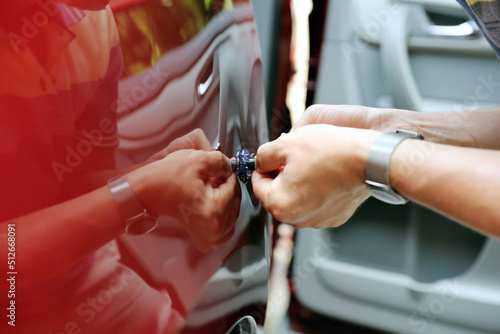 Man fixing car  dent by himself