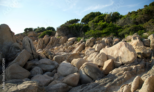 Corse rock , sea and blue sky. Landscape of a beach fulled with giant boulder of granite stones.