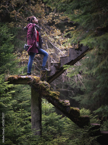 woman on the stairs to nowhere in the forrest