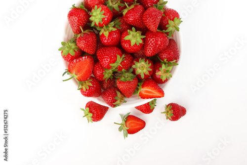 Red ripe strawberry in the white bowl