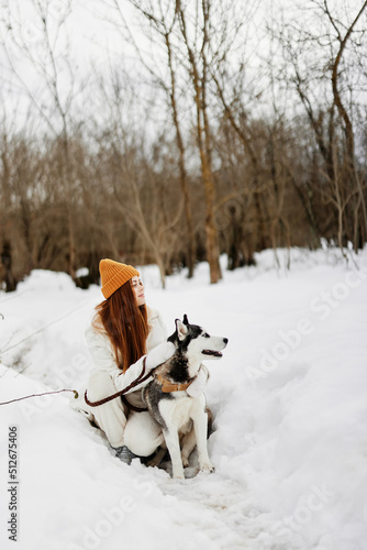 Fototapeta Naklejka Na Ścianę i Meble -  portrait of a woman winter outdoors with a dog fun nature fresh air