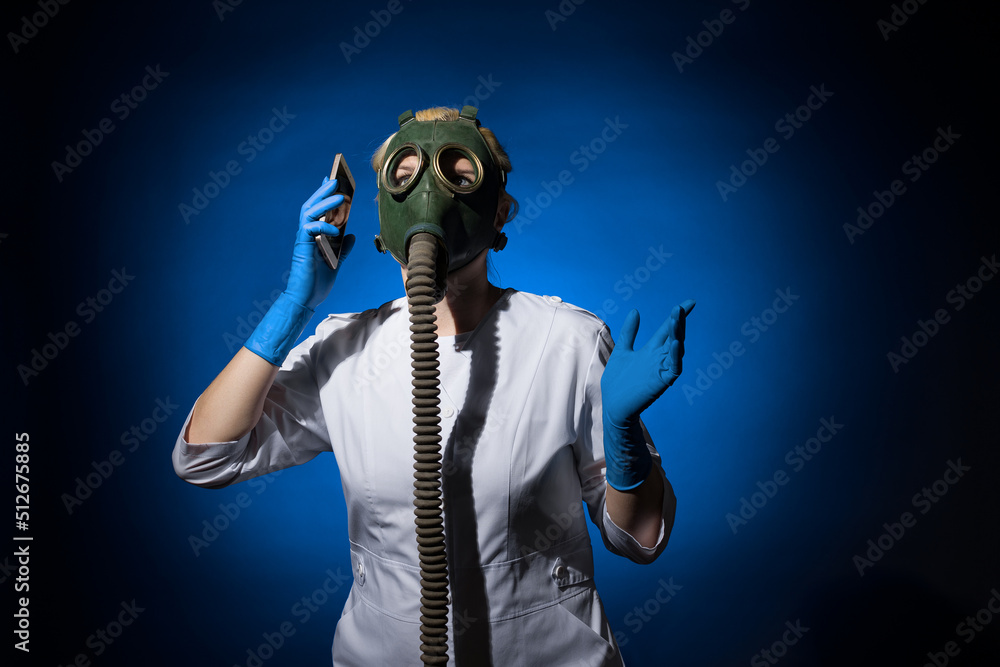 doctor woman in a gas mask talking on the phone on a blue background