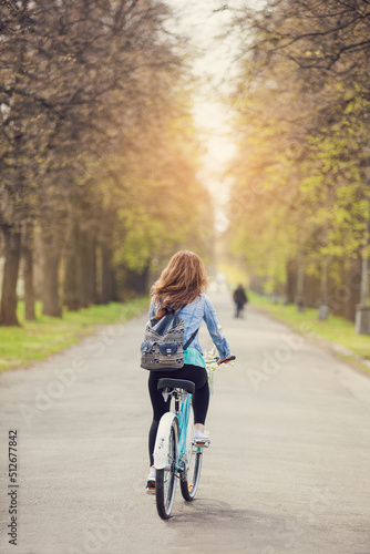 woman on bicycle in park