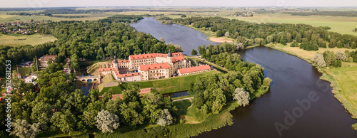 Aerial view of Nesvizh Castle and river, Belarus. Medieval castle and palace. Restored medieval fortress.
