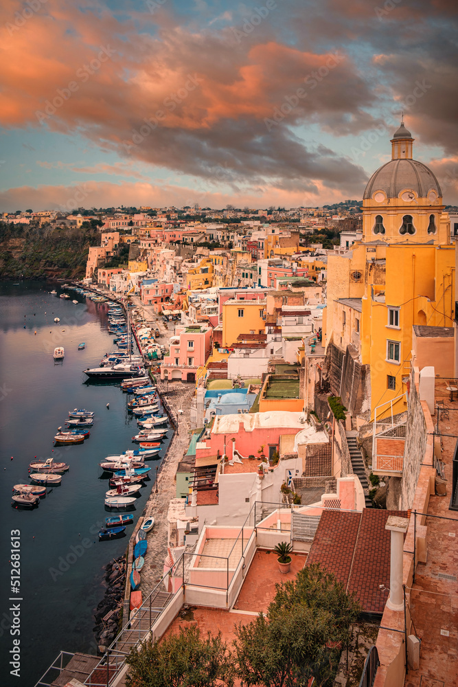 Marina Corricella at sunset, Isle of Procida, Naples, Italy. Corricella, the oldest fishing village in Procida, is built on a natural amphitheater.
