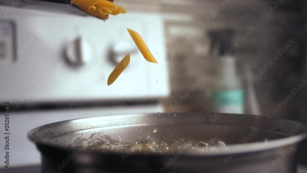 Super slow motion of pasta falling into a pot with boiling water. Filmed on a high-speed cinema camera, 1000 fps Super slow motion of pasta falling into a pot with boiling water. Filmed on a high-speed cinema camera, 1000 fps