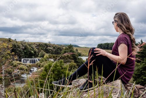 adventurous woman looking at waterfall view © MMV