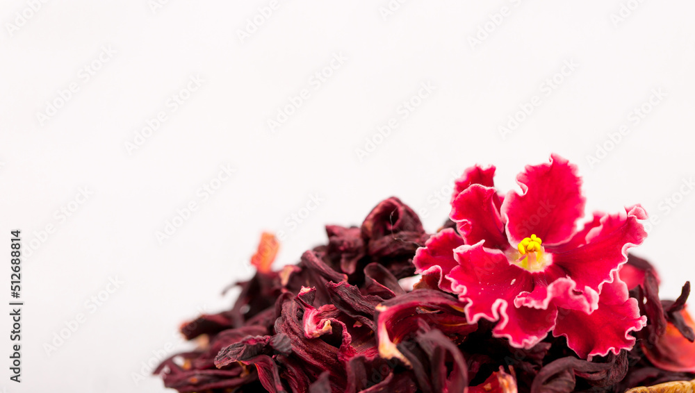 Flower tea karkade. Delicious herbal tropical drink on a bright table. A cup of pink tea from dry hibiscus petals, a natural medicinal drink against the background of fern leaves. Tropical morning. Flower tea karkade. Delicious herbal tropical drink on a bright table. A cup of pink tea from dry hibiscus petals, a natural medicinal drink against the background of fern leaves. Tropical morning.