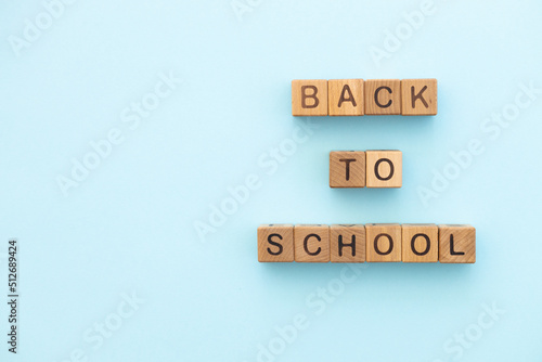 Back to school written of wooden cubes on blue background