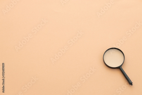 magnifying glass on beige background. Search concept