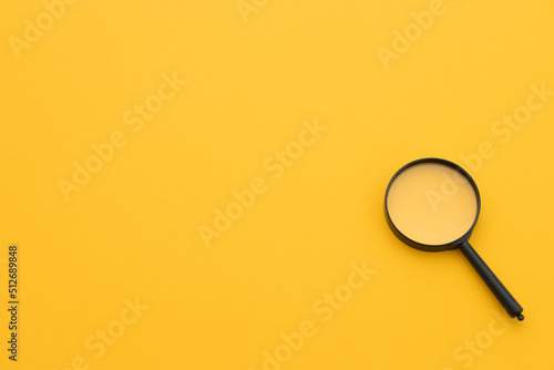 magnifying glass on yellow background. Search concept