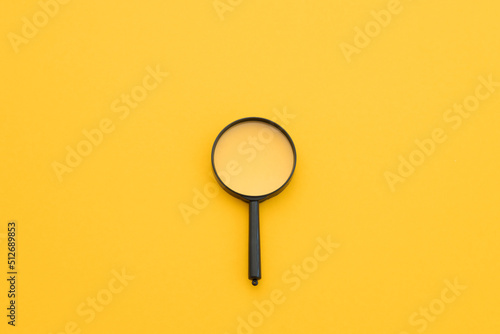 magnifying glass on yellow background. Search concept