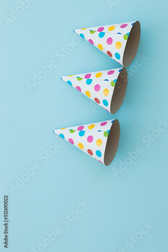 Colorful birthday caps isolated on blue
