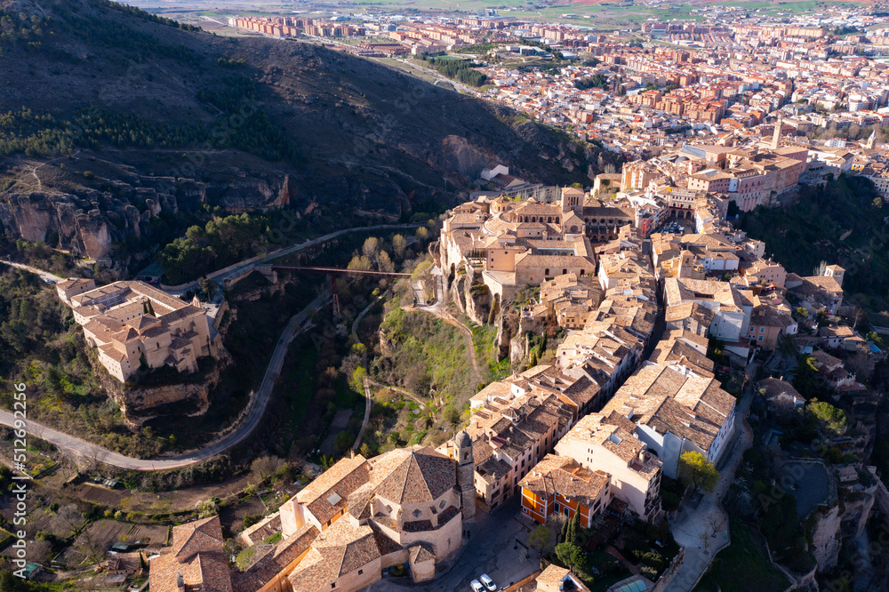 Picturesque view from drone of historic district of Cuenca city on steep spur above deep gorges of Jucar and Huecar rivers on sunny spring day, Spain