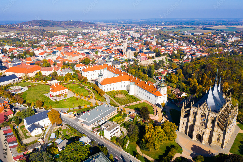 Panoramic view from drone of Czech town of Kutna Hora overlooking medieval Jesuit College and St. Barbara Cathedral on sunny autumn day, Central Bohemian Region..