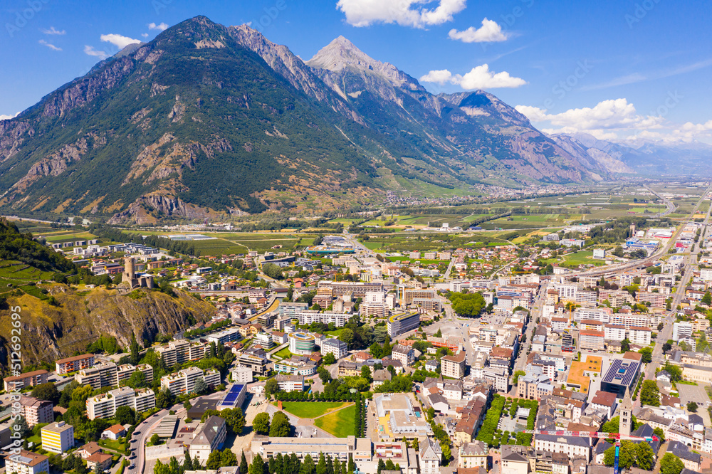 View from drone of houses of commune Martigny and river Drance in mountain valley, Switzerland