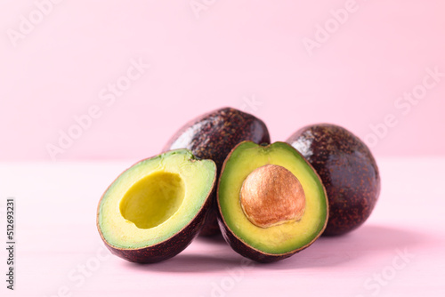Ripe avocado fruit ready to eating on pink background