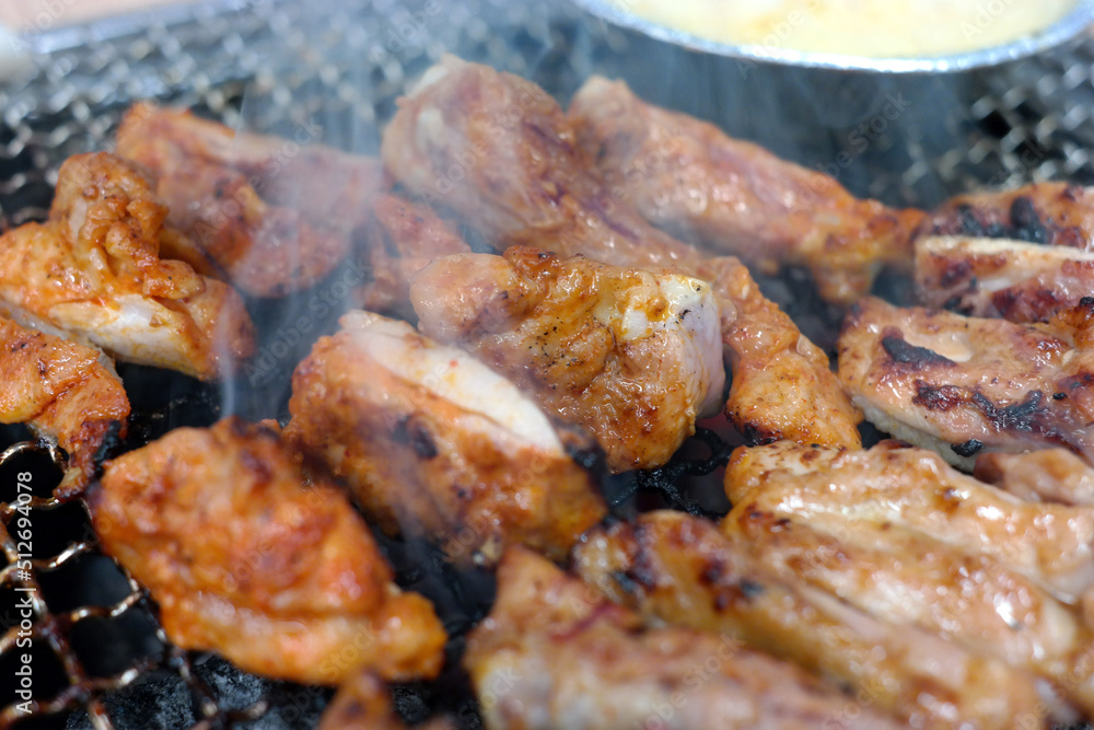 Chicken ribs are grilled over the fire with smoke.