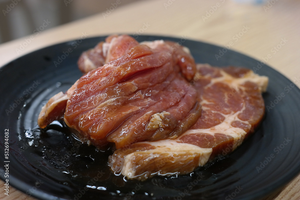 Seasoned pork ribs are served on a plate.