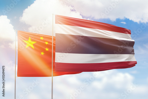 Canvas Print Sunny blue sky and flags of thailand and china