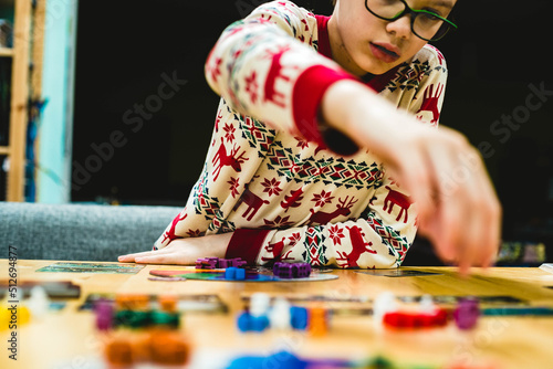 Boy playing a board game making his move