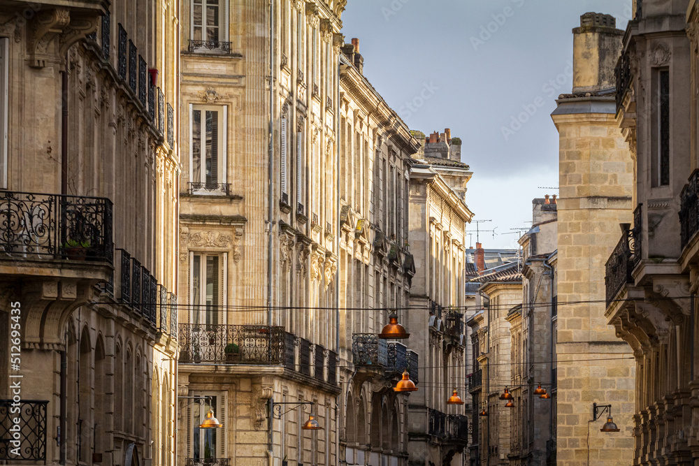 Facade of medieval buildings in a dark street, narrow, in the city center of Bordeaux, France. These buildings are typical of the Southwestern French architecture..... Facade of medieval buildings in a dark street, narrow, in the city center of Bordeaux, France. These buildings are typical of the Southwestern French architecture.....