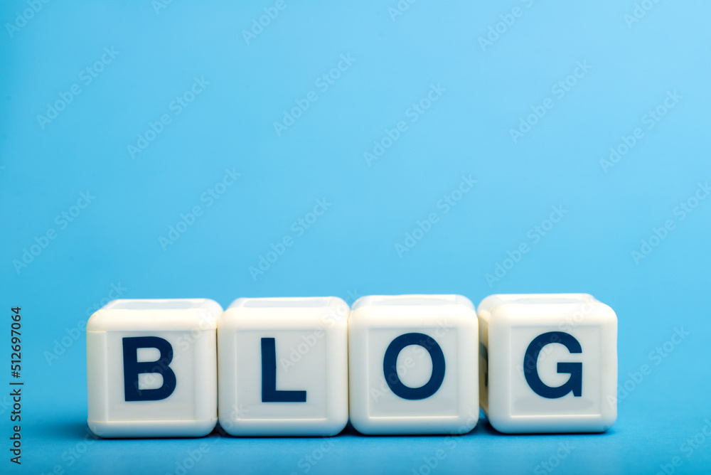 Blog. Word from letters on wooden cubes. On a blue background. Blog. Word from letters on wooden cubes. On a blue background.