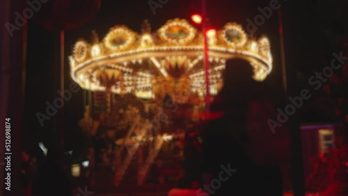 Illuminated Merry Go Round Carousel Rotating in an Amusement Park at Night photo