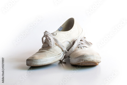 The old vintage white sneakers dirty isolated on white background.