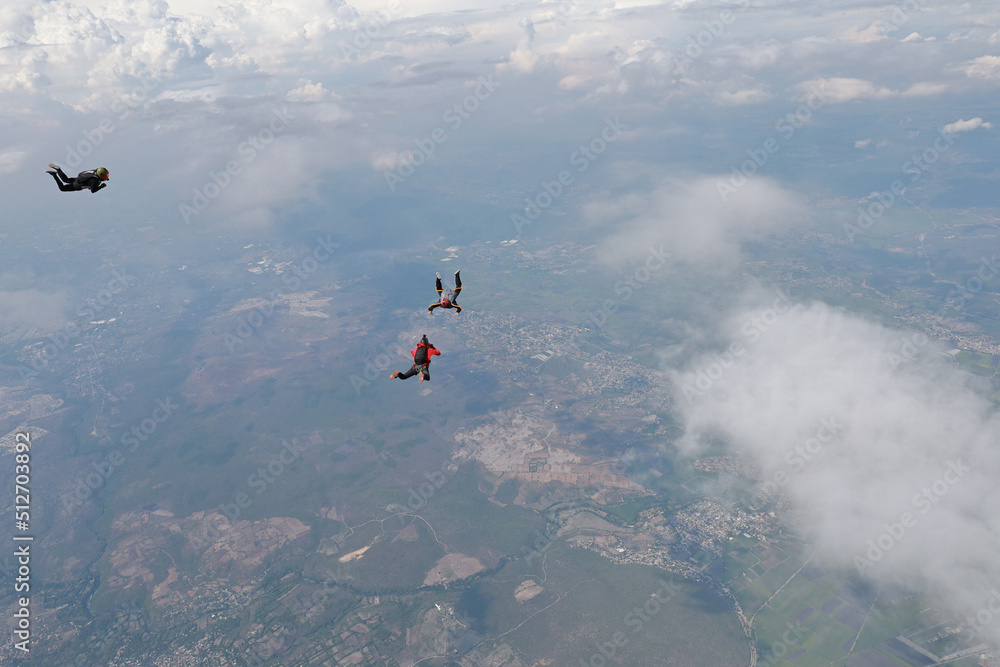 Fototapeta premium Skydiving. Skydivers are training in the cloudy sky.