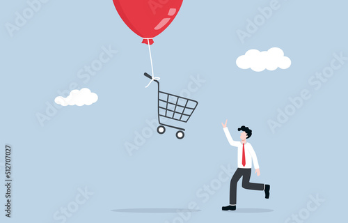 Inflation affects purchasing power, prices of products unusually rise up concept. Businessman consumer trying to catch shopping cart that being flying into the sky by inflation balloon. 