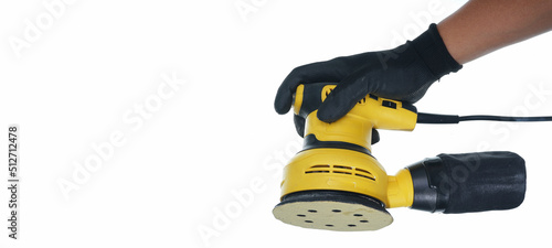hand wearing black gloves holding orbital sander isolated white background