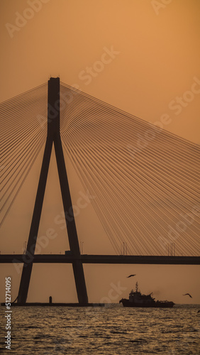 Canvas Print sunset near mumbai worli bandra sea link bridge and small boat in ocean