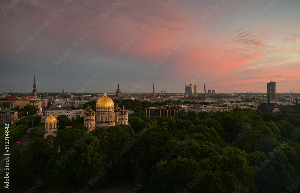 Beautiful summer sunset over the central district of Riga, with view to Freedom Monument, Old town and Cathedral. Landmarks of Latvia.