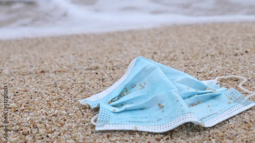 Coronavirus COVID-19 is contributing to pollution. Used face mask polluting tropical beaches. Polluted ocean coast with garbage. Environmental and ocean pollution concept during coronavirus pandemic. Coronavirus COVID-19 is contributing to pollution. Used face mask polluting tropical beaches. Polluted ocean coast with garbage. Environmental and ocean pollution concept during coronavirus pandemic.