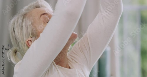 Closeup of one senior caucasian woman meditating in harmony with hands in namaste gesture while practising yoga. Face of calm relax lady breathing to feel zen while praying for stress relief and peace