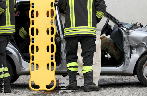 Fototapeta firefighters during rescue of the injured after the car accident with the stretc