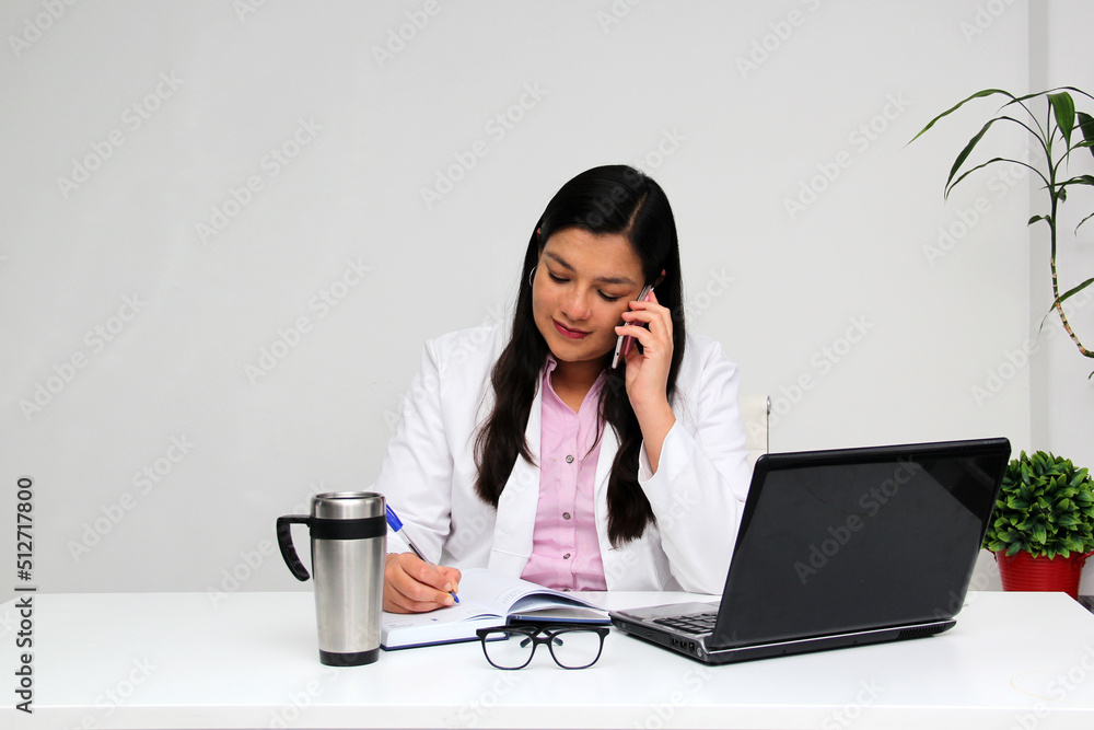 Latina doctor woman works in her office very busy uses her cell phone to answer messages, calls and video calls from patients
Latina doctor woman works in her office very busy uses her cell phone to answer messages, calls and video calls from patients