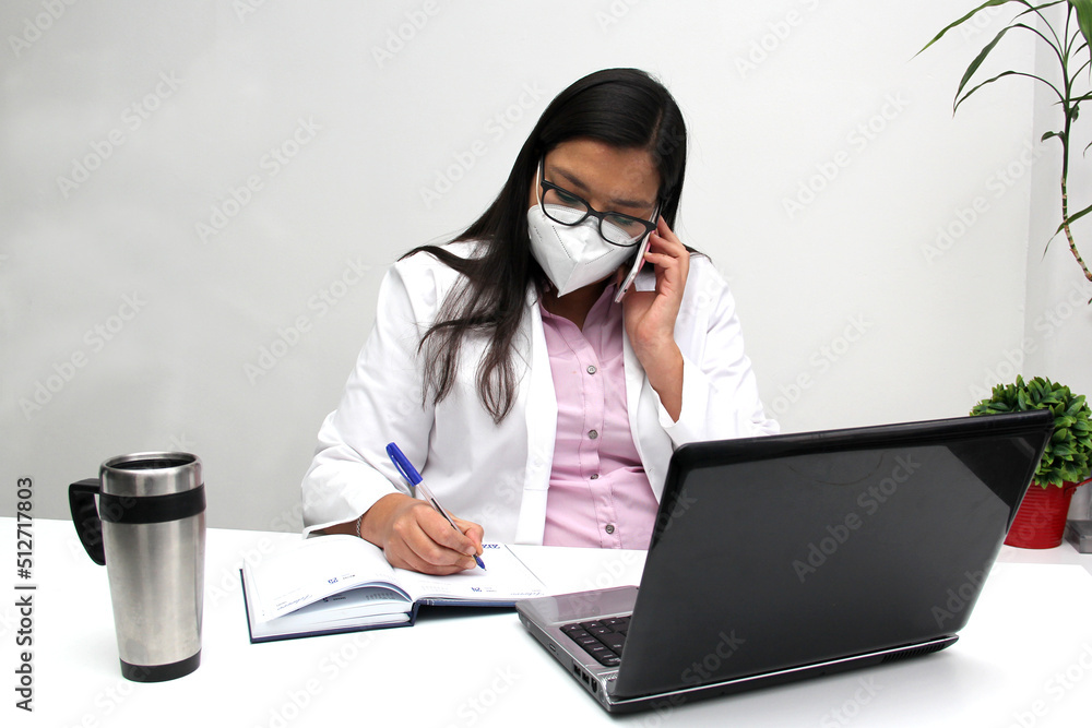 Latina doctor woman works in her office very busy uses her cell phone to answer messages, calls and video calls from patients
Latina doctor woman works in her office very busy uses her cell phone to answer messages, calls and video calls from patients