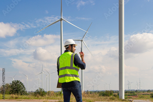 engineer team working in wind turbine farm. Renewable energy with wind generator by alternative energy concept. worker foreman engineer works with the walkie-talkie to order the work.