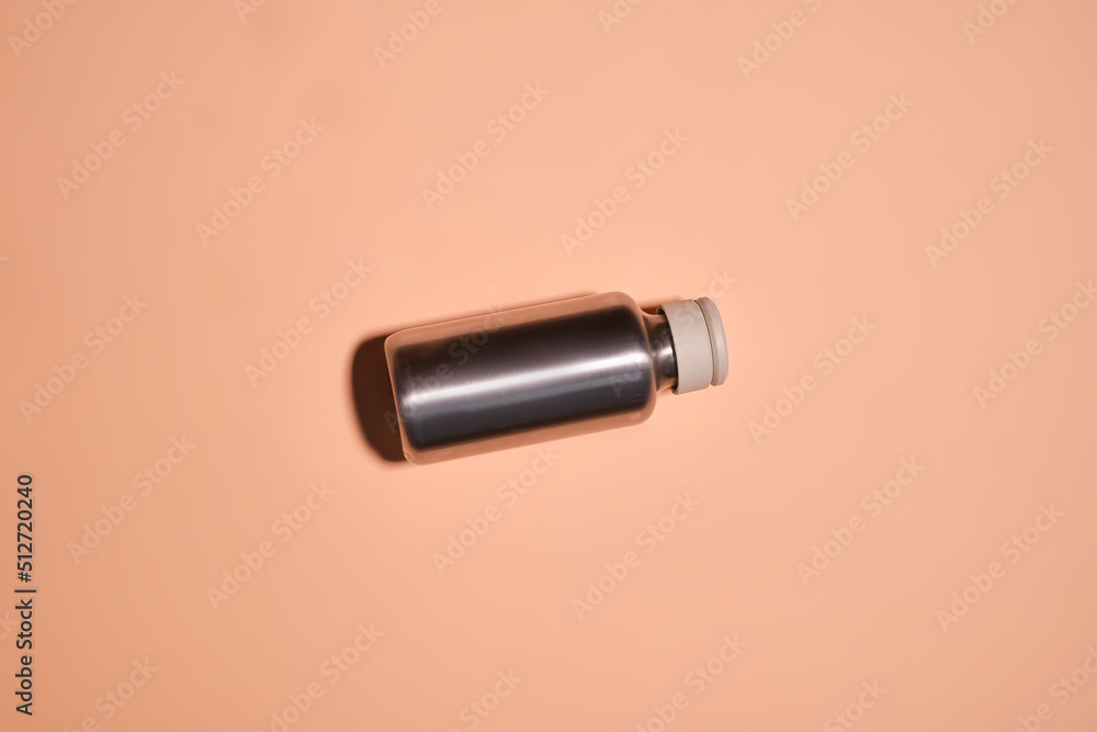Reusable iron water bottle in a woman's hand. Steel water bottle to limit the use of plastic bottles Reusable iron water bottle in a woman's hand. Steel water bottle to limit the use of plastic bottles