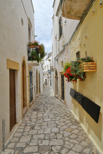 A narrow street among the old houses in the historic center of Otranto, a town in Puglia in Italy.