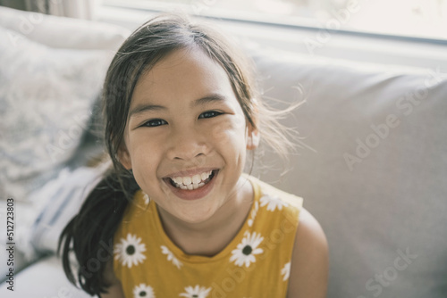 Принти на полотні Portrait of happy young mixed Asian preteen tween girl child smiling at home
