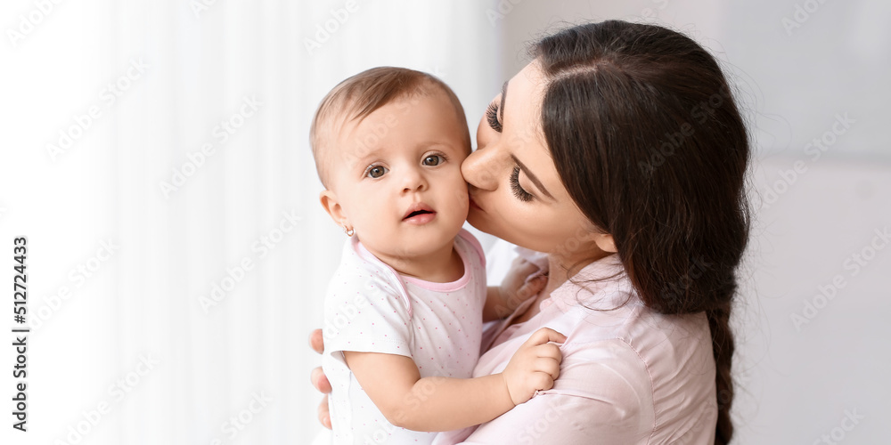 Happy mother kissing her cute little baby at home Happy mother kissing her cute little baby at home