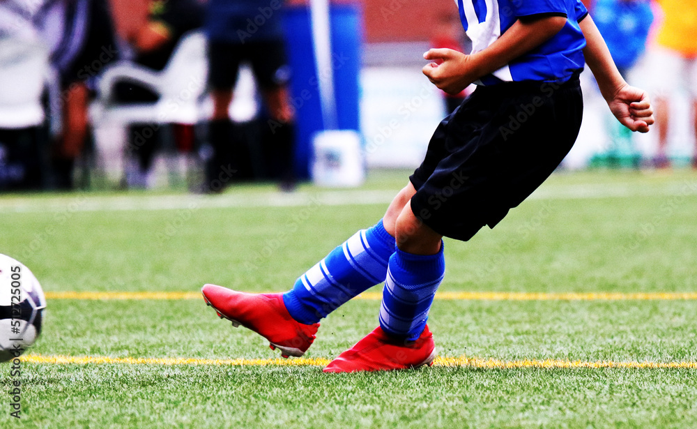 Junior soccer player kicking the ball Junior soccer player kicking the ball