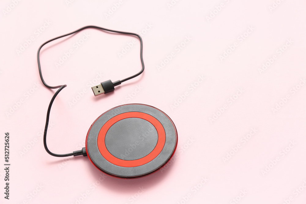 Wireless charger pad and cable on color background Wireless charger pad and cable on color background