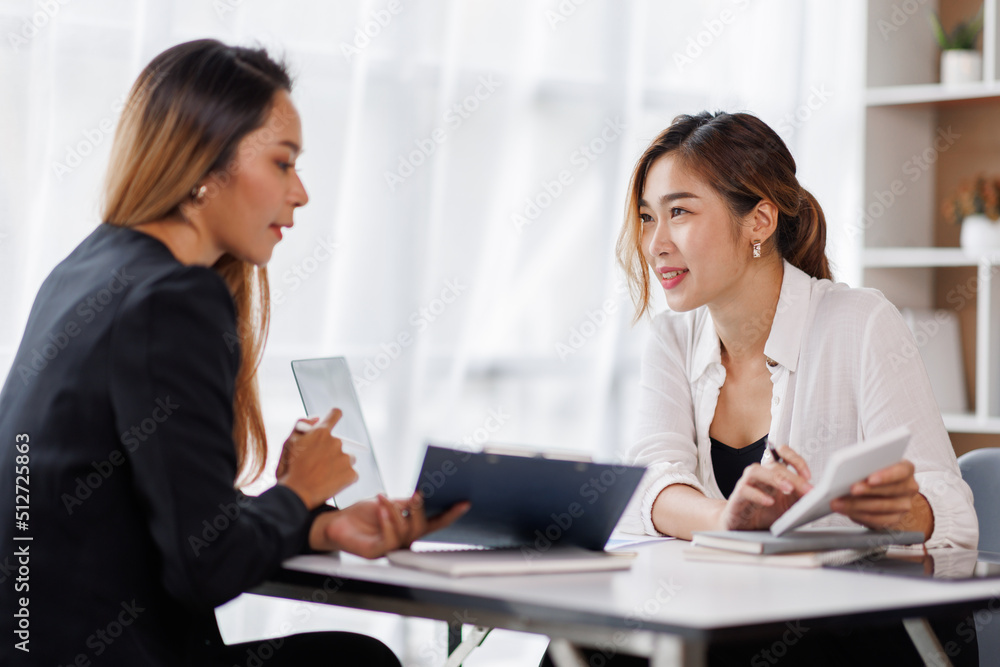 Cropped shot of Asian Business woman diverse coworkers working together in the boardroom, brainstorming, discussing, and analyzing business report strategy collaboration. Cropped shot of Asian Business woman diverse coworkers working together in the boardroom, brainstorming, discussing, and analyzing business report strategy collaboration.